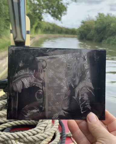 Tin Plate Collaboration A tin type black and white photograph of a woman in the hatches of a narrowboat. The plate has been engraves with wood engraving tools.